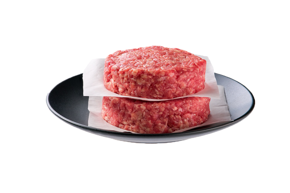 Twee rauwe hamburgers van huisgemaakt gehakt op bakpapier, klaar voor de grill of de pan
